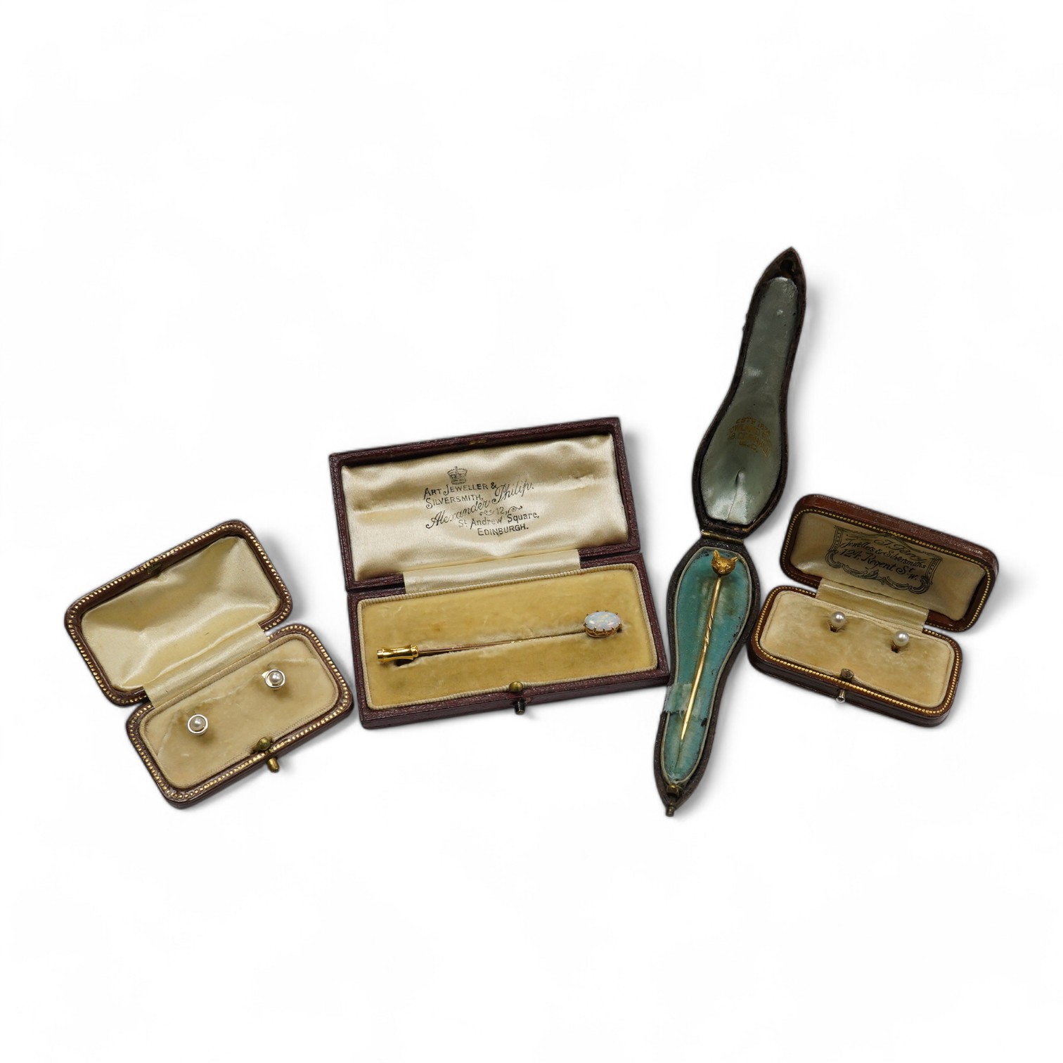 A group of gentleman's accessories, early 20th century, comprising: two pairs of cultured pearl collar studs, one set marked 15CT, each with fitted cases; a stick pin topped with the head of a fox, indistinct mark to pin